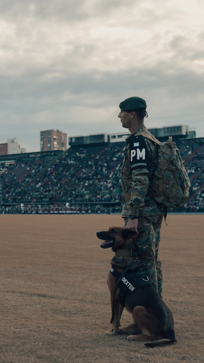 Military police officer stands with detection dog in a stadium in Buenos Aires, Argentina.